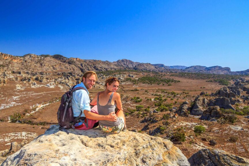 Young hiker couple viewing scenic panorama at Madagascar’s Isalo National Park.