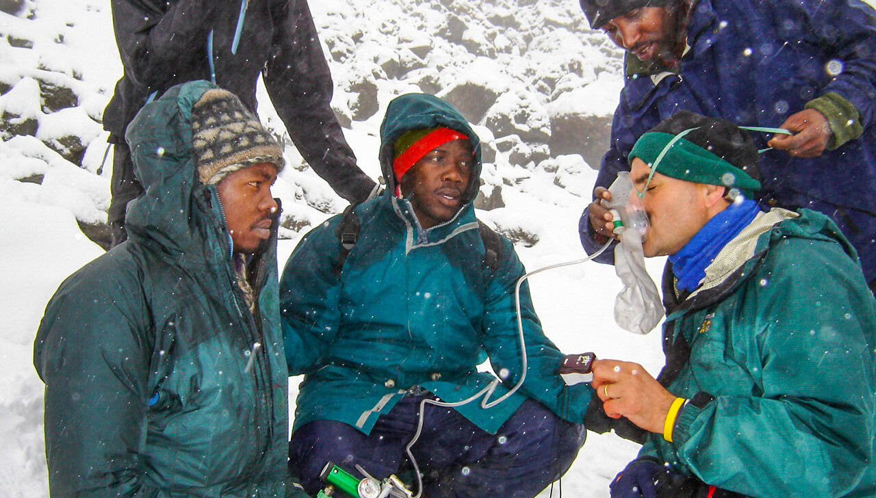 A man using an oxygen mask at Mt. Kilimanjaro.