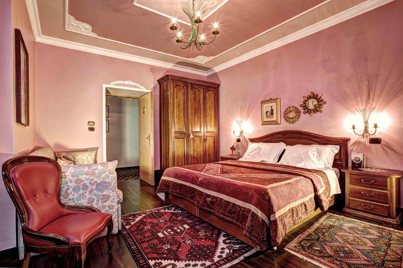 https://www.wildernesstravel.com/wp-content/uploads/2023/08/10-romantik-hotel-regina-bedroom-red-1680x1120.jpg